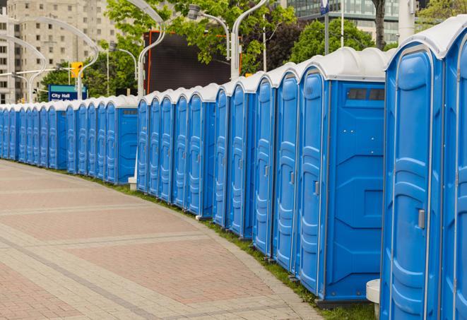 a row of portable restrooms set up for a large athletic event, allowing participants and spectators to easily take care of their needs in Berkeley Heights